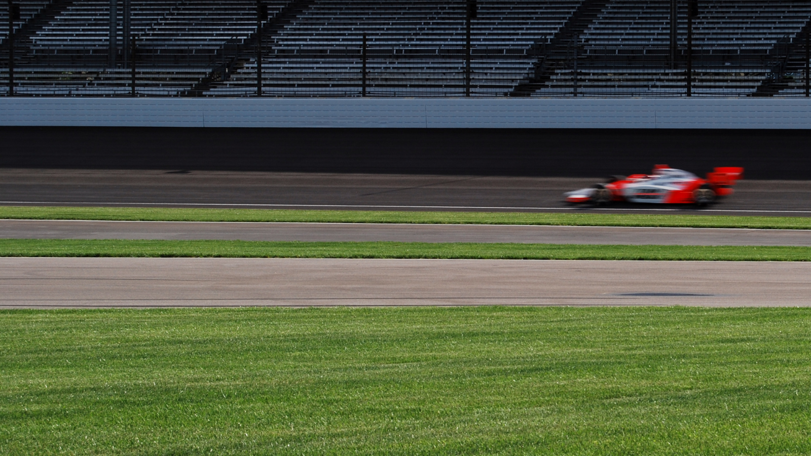 far shot of an indy car going around the track