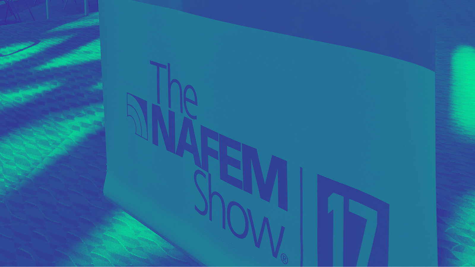 close up of NAFEM Show banner with green filter