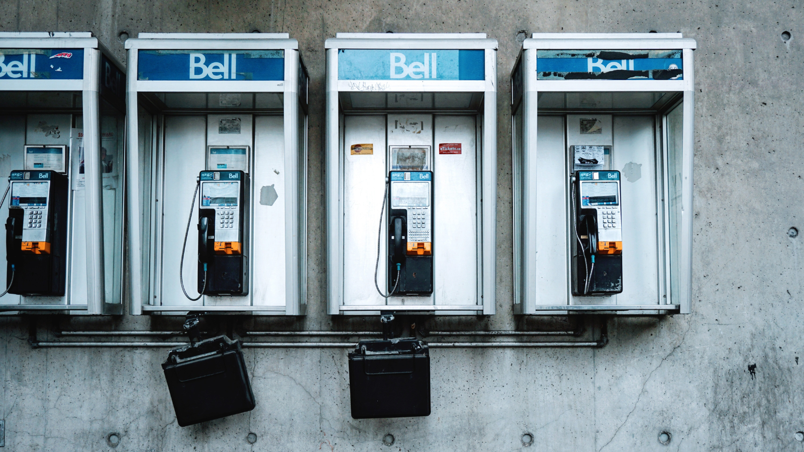 four phone booths on a wall